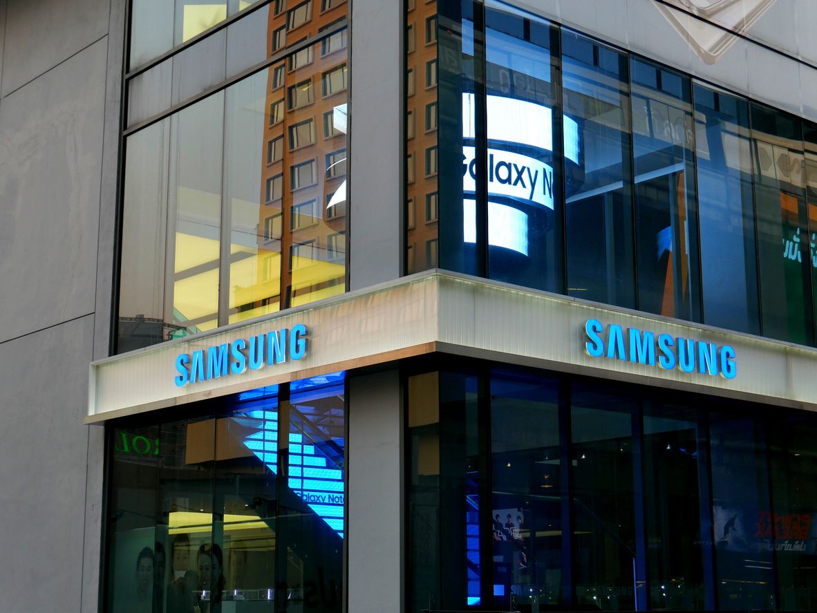 Bangkok, Thailand – December 10, 2015: Exterior view of a Samsung shop in the Siam Square area of Bangkok, Thailand. People walk around the area. The picture is taken from the walkway of sky train station.