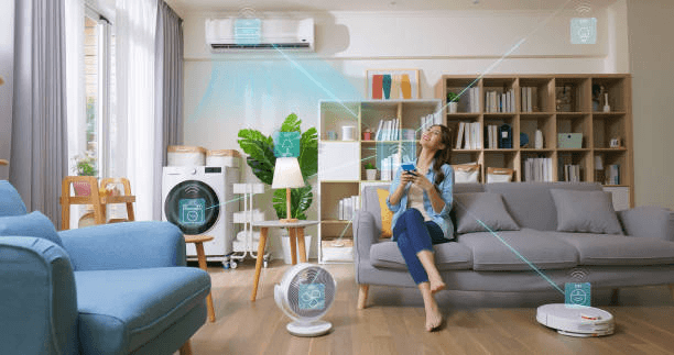 photo of a woman sittiing in a living room on her smartphone surrounded by smart devices.