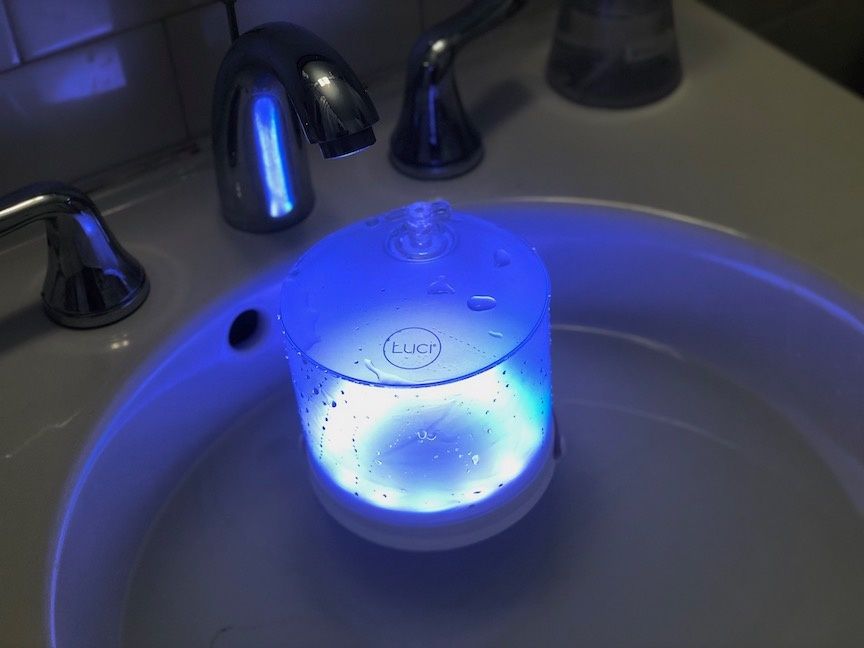 A Luci Connect solar-powered lantern floating in water