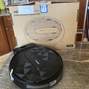  A photo of Airrobo P20 Robot Vacuum and its box on a countertop