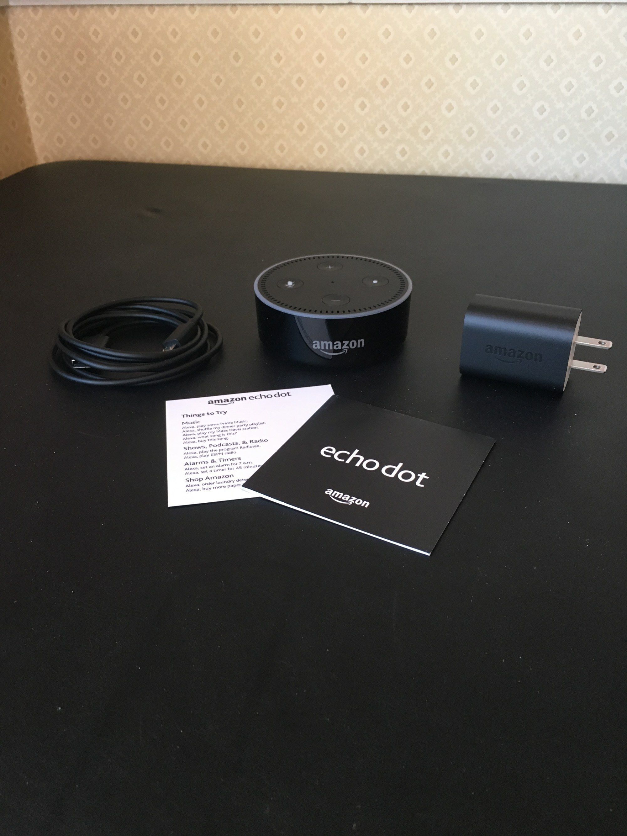 a photo of echo dot 1st gen unboxed on a table