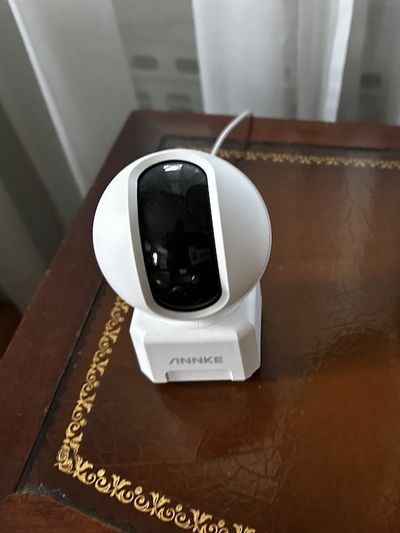 a photo of Annke Crater Pro Dual-Band WiFi Indoor Camera on an end table