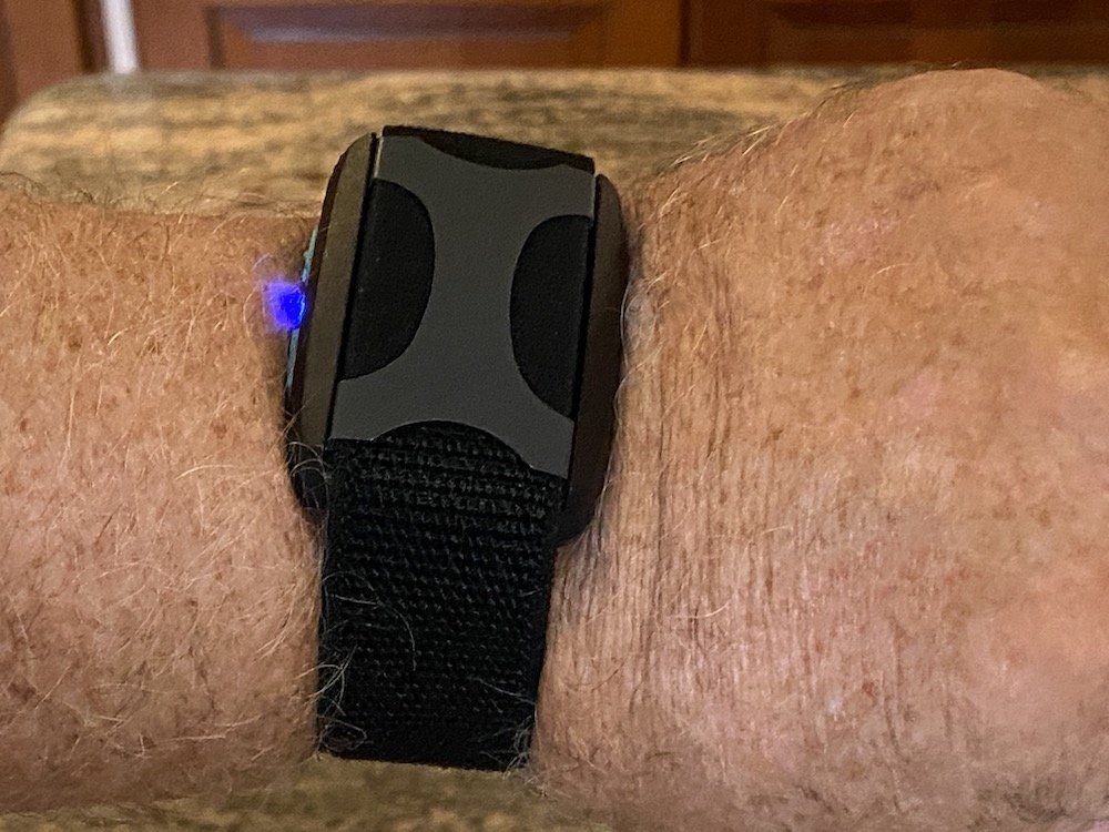 a photo of Apollo Wearable on a wrist pairing with a smartphone.
