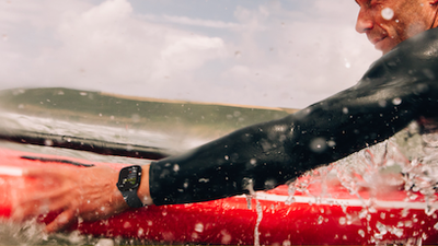 a photo of a male surfer wearing Apple Watch 10