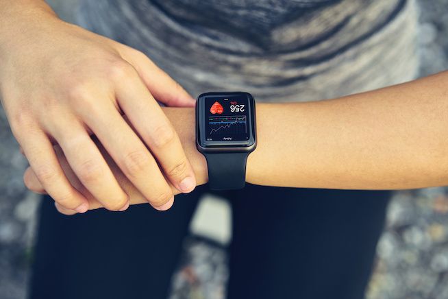 A woman looking at her heart health from her wearable device