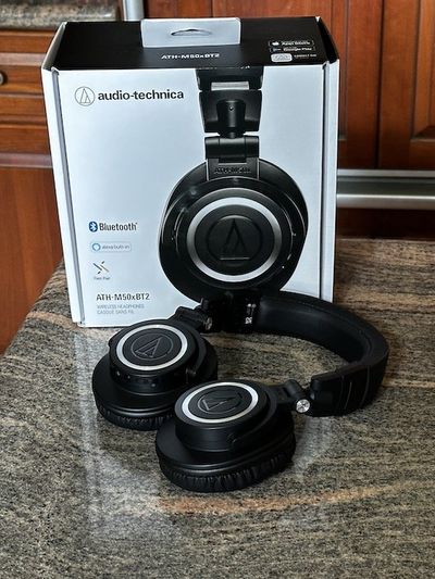 a photo of audio-technica ATH-M50xBT2 Wireless Headphones and box on a countertop