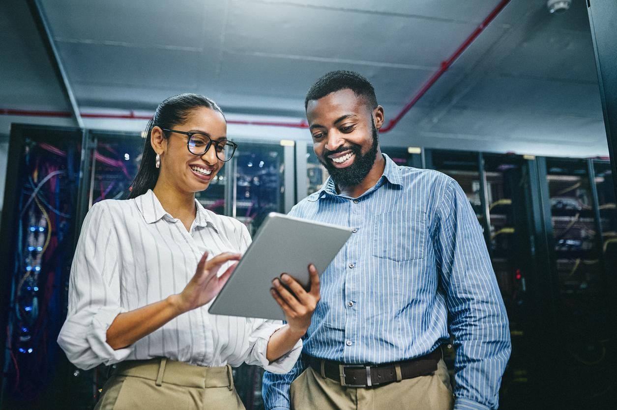 two technicians workiing in a server room