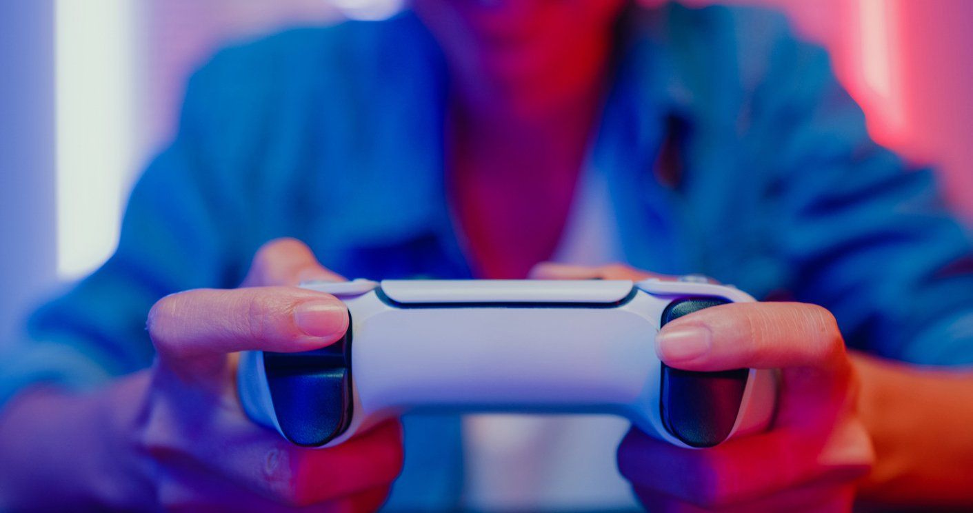 a photo of a woman playing video games holding a game controller