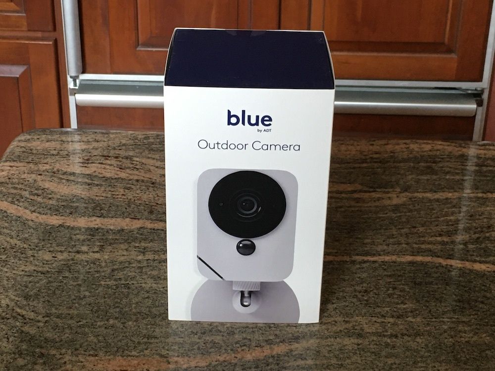 blue by adt outdoor camera in a box on a counter