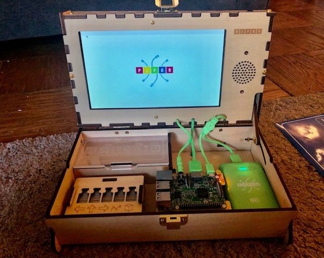 A Piper Computer Kit 2 put together with the display lit, and reading 'Piper'