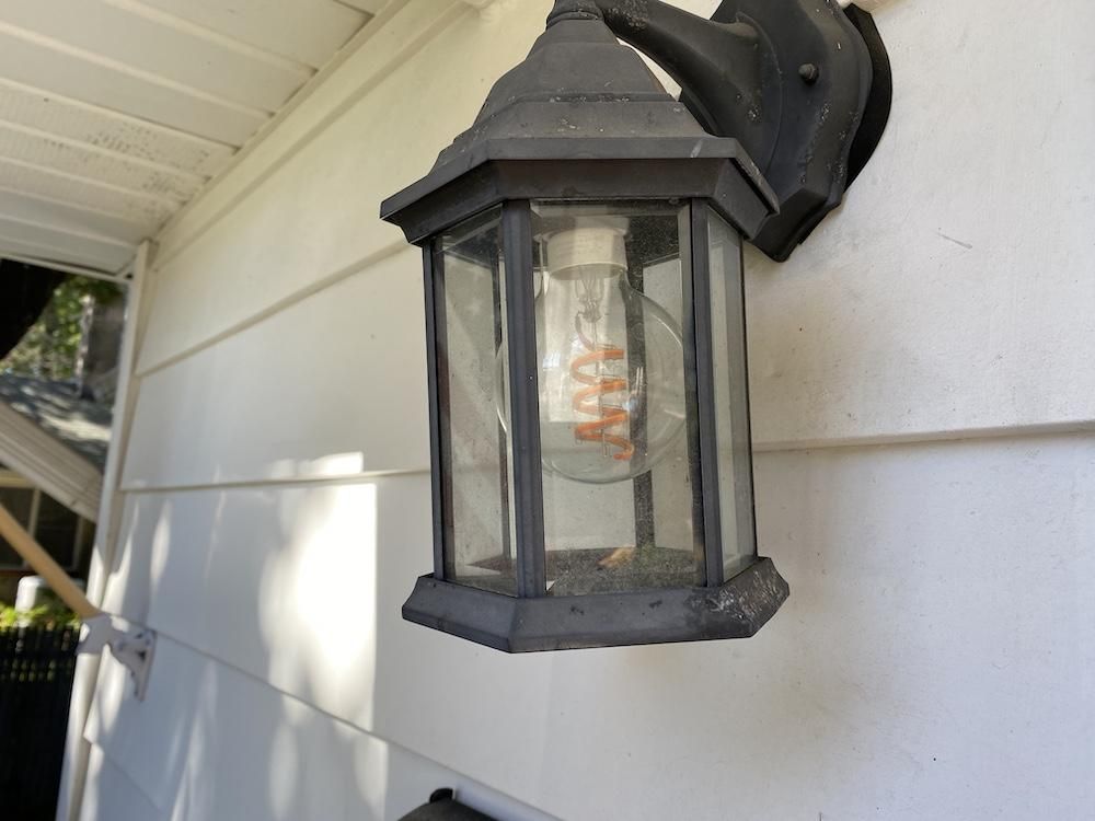 a photo of a Cync Decorative Smart Bulb in a sconce on a home.