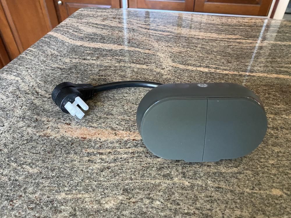 Cync Outdoor Smart Plug on a countertop unboxed.