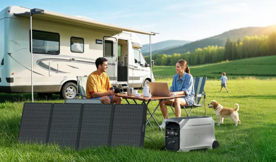 a couple sitting at a campsite next to an RV and ecoflow power station and portable solar panel