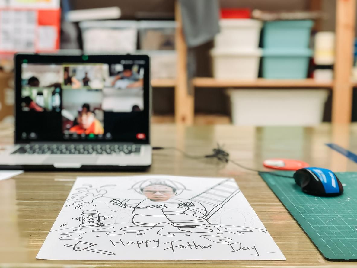 a photo of a computer with a father's day drawing on a desk.