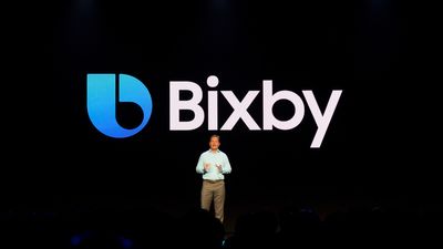 a person standing in front of a Bixby logo on stage