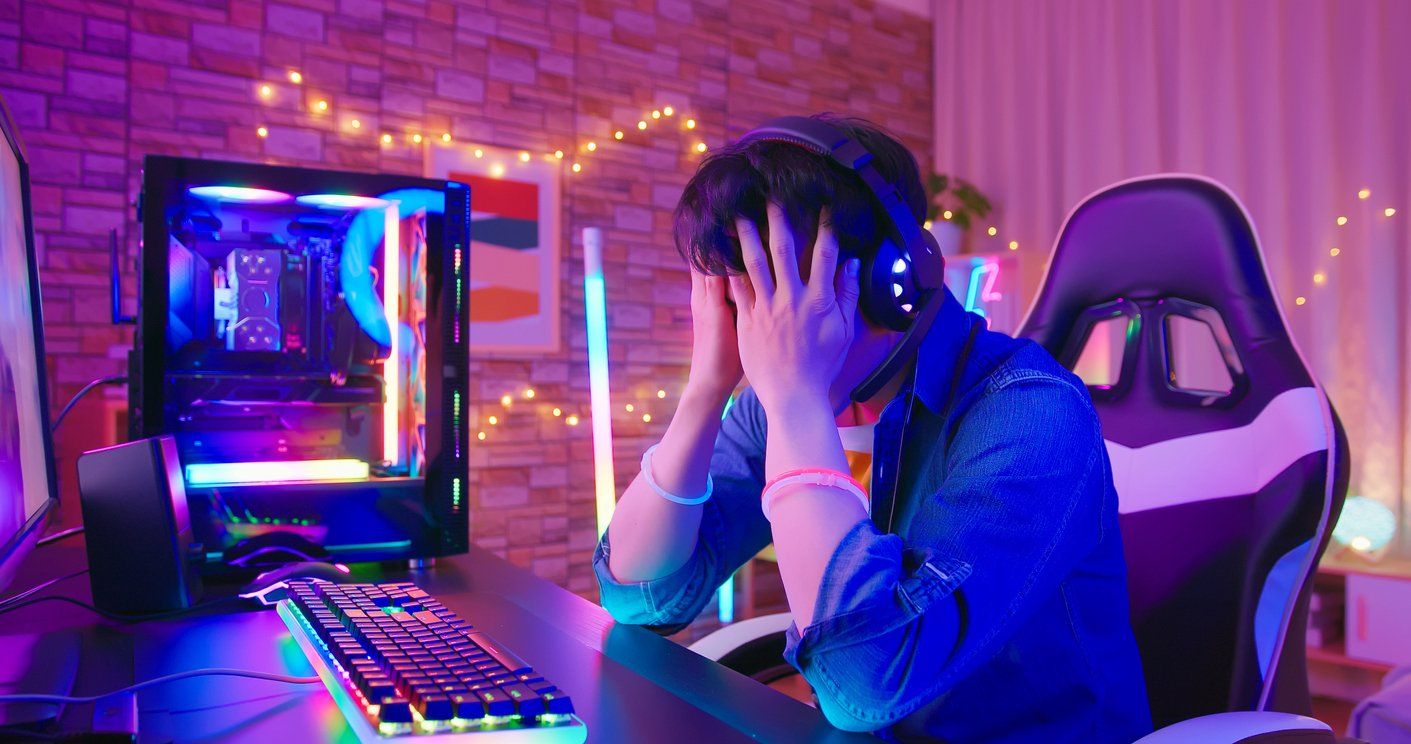 a gamer who just lost sitting at his computer