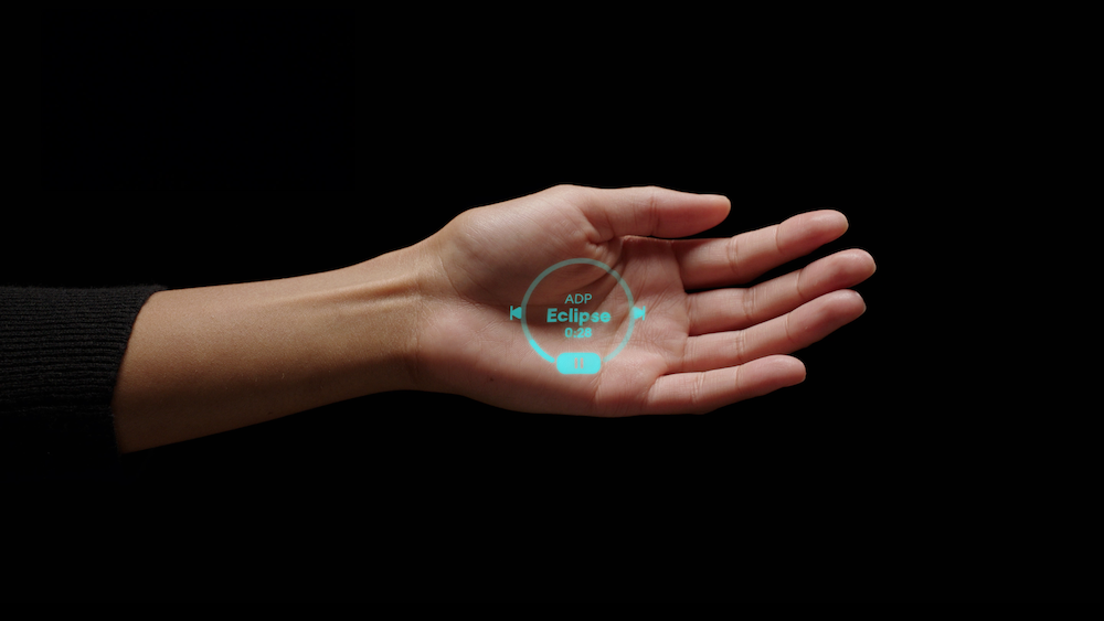 a photo of a woman's hand showing a message from humane ai pin