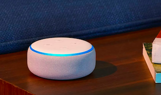 A white, fabric-covered Amazon Echo Dot on a dark wood table