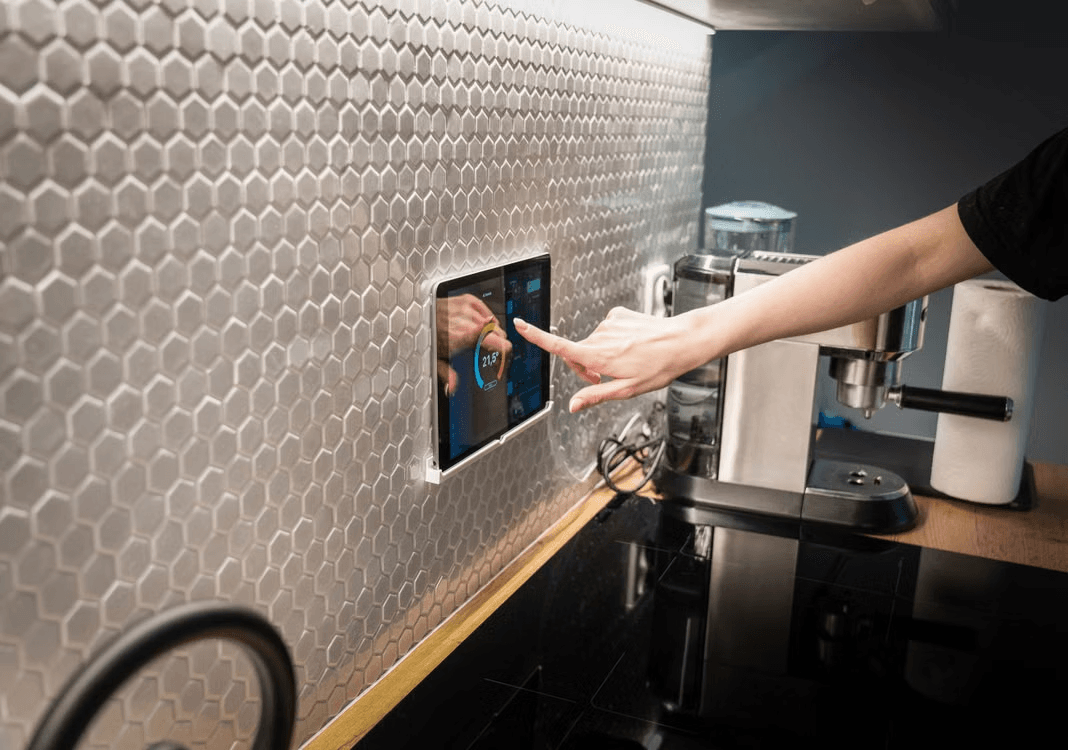 photo of a person touching a home hub screen