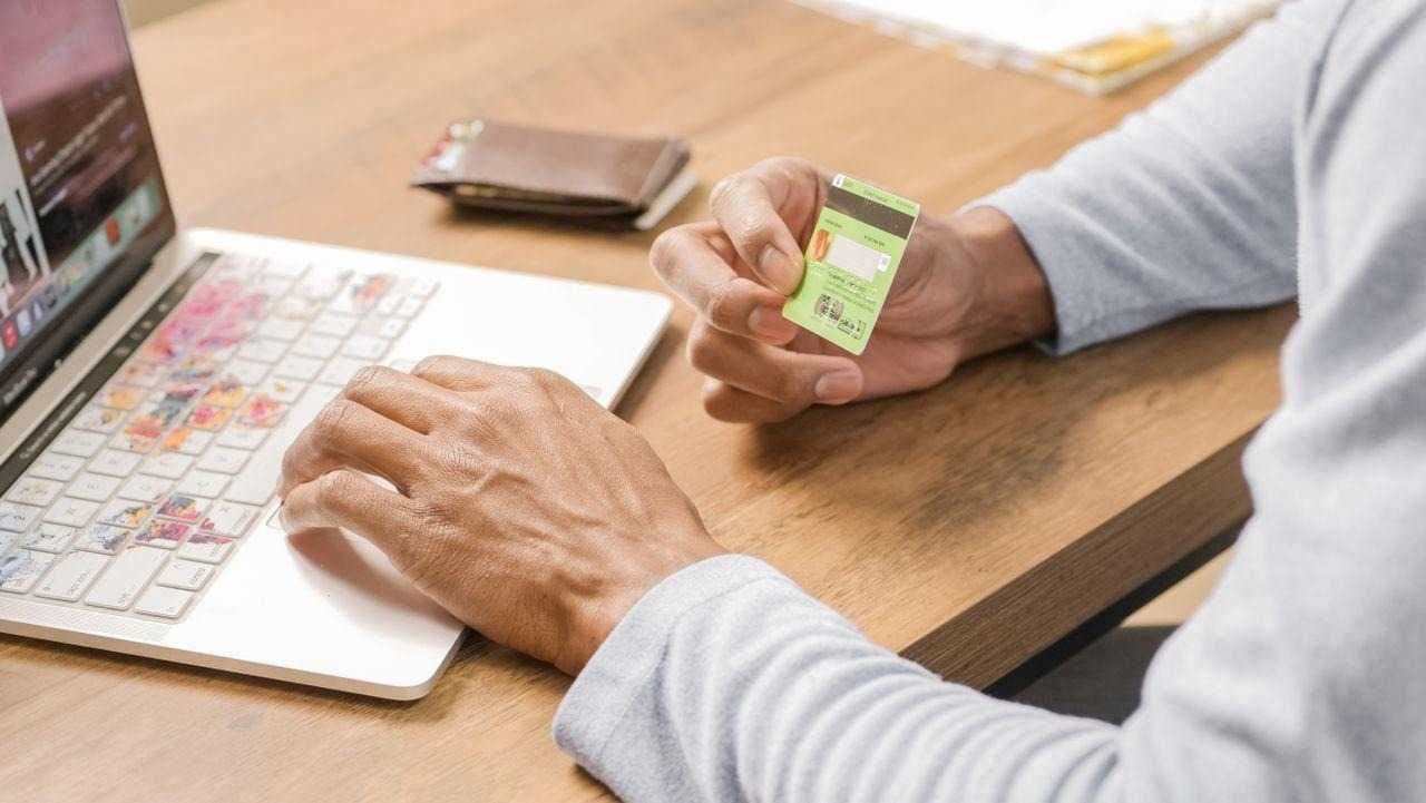 man on a laptop using his credit card