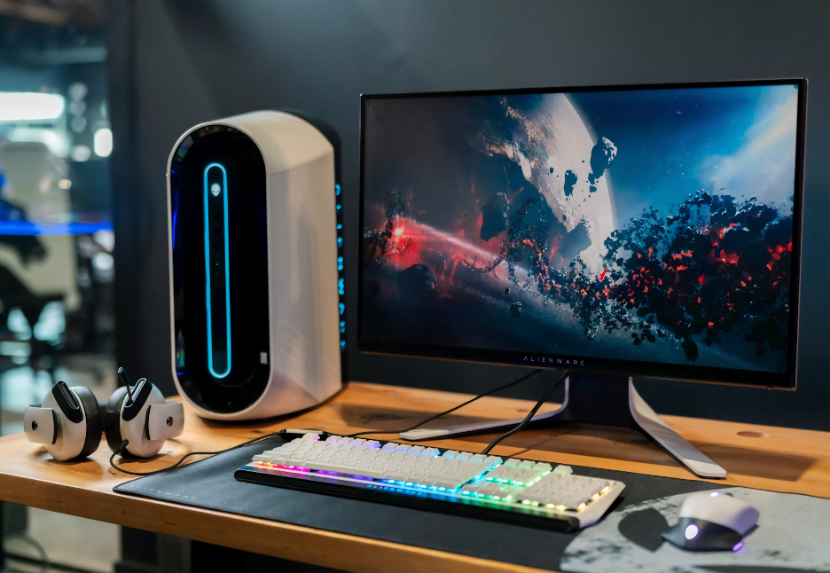 photo of a home office with keyboard, moust, speaker and tower computer and screen