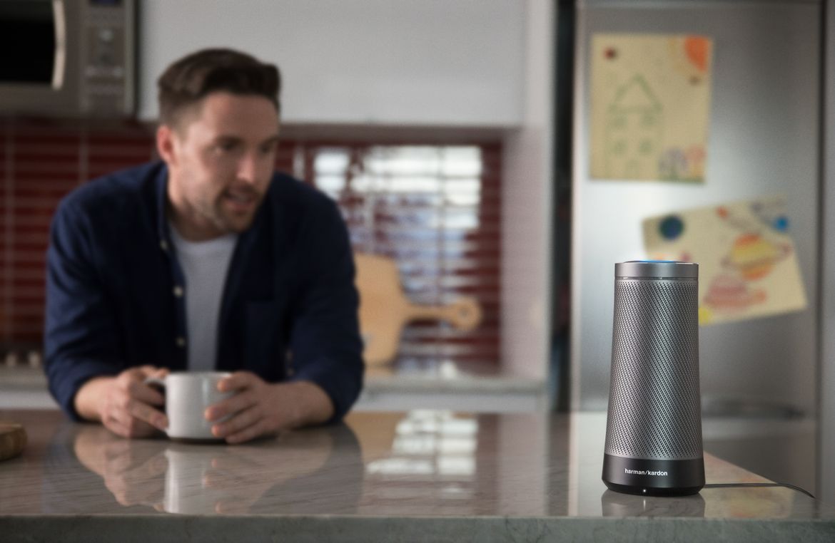 a photo of a man in a kitchen with Invoke Smart speaker