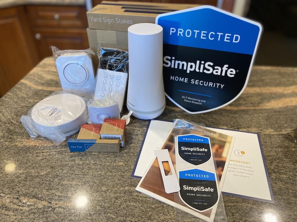 The SimpliSafe Hearth Home Security System unboxed on a counter.