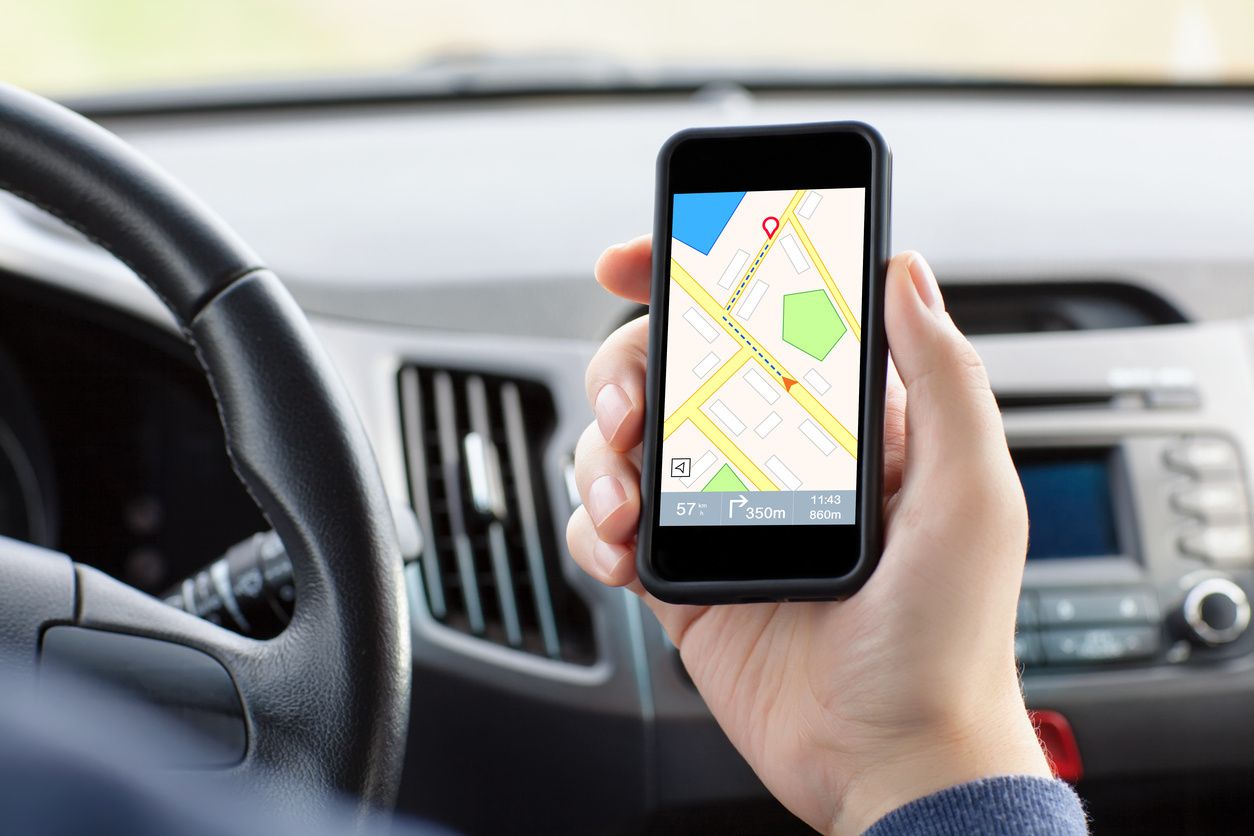 a photo of a man holding a smartphone showing a map