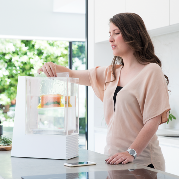  a photo of woman using a food processor