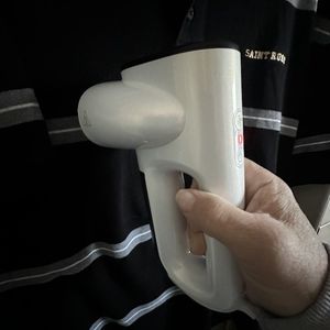 a photo of Neakasa Magic Vacuum Steamer steaming a shirt