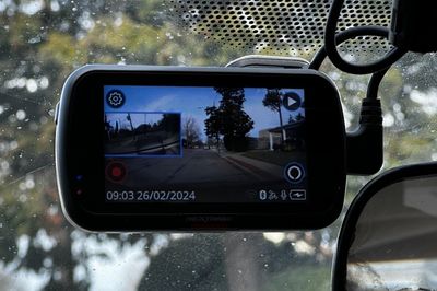 a photo of Nextbase 622GW 4K Dash Cam installed on a windshield inside a car
