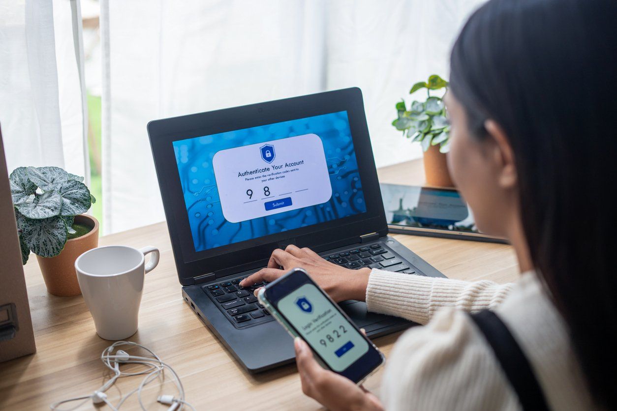 Two-Factor Authentication (2FA) security login in securely to her laptop stock photo
