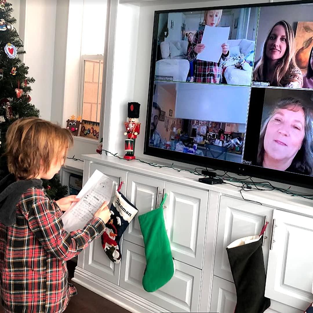 ONSCREEN being used by a. child and her family on a big screen TV.