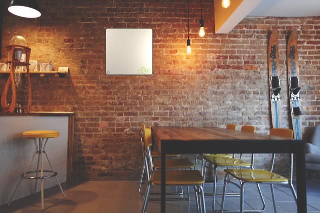 Photo of a office breakroom with Ossia Cota Wireless Power system on the wall.