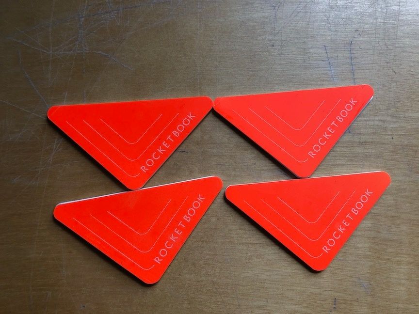 Four orange Rocketbook Beacons stickers
