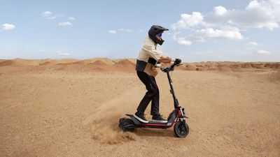 a man riding a Segway ZT3 Pro scooter in the desert