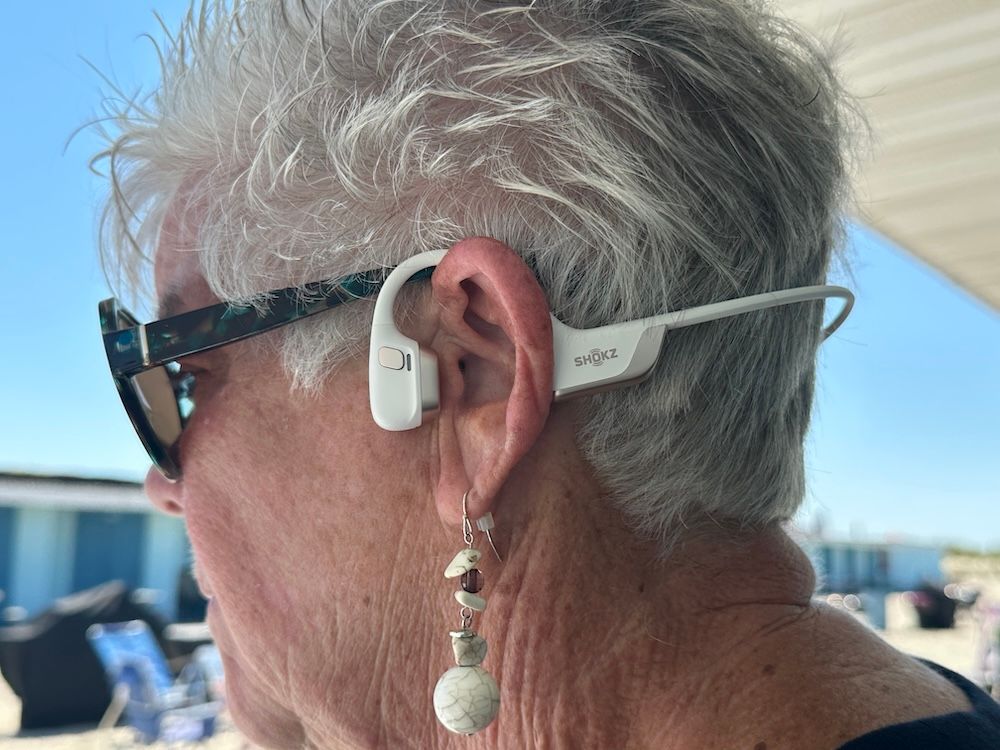 photo of a woman wearing Openrun Pro 2 headphones.