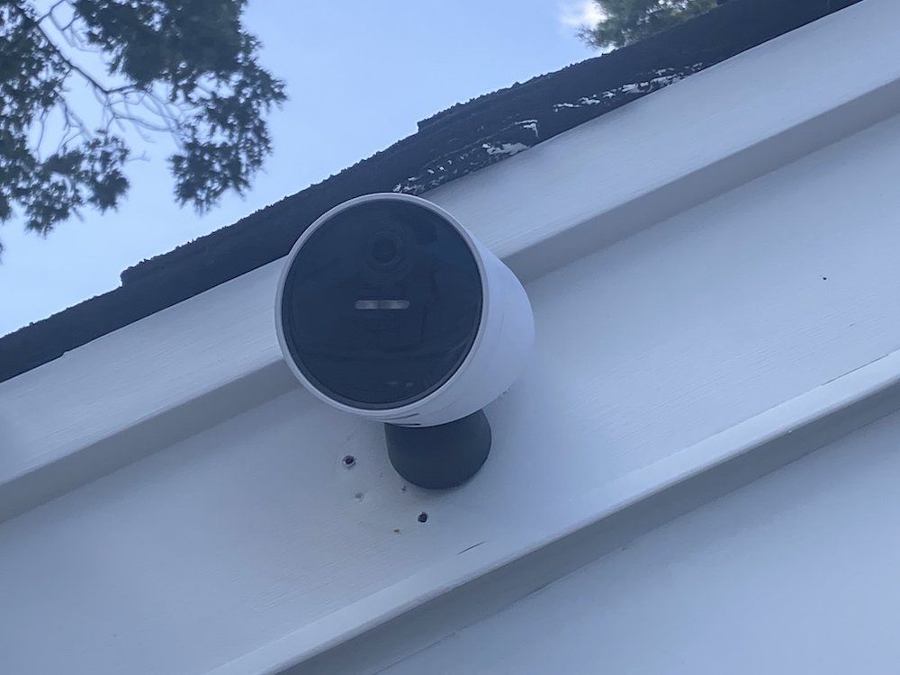 a photo of SimpliSafe Wireless Outdoor Security Camera installed on a garage.