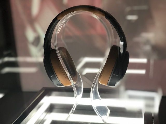 Black and tan headphones on a glass table
