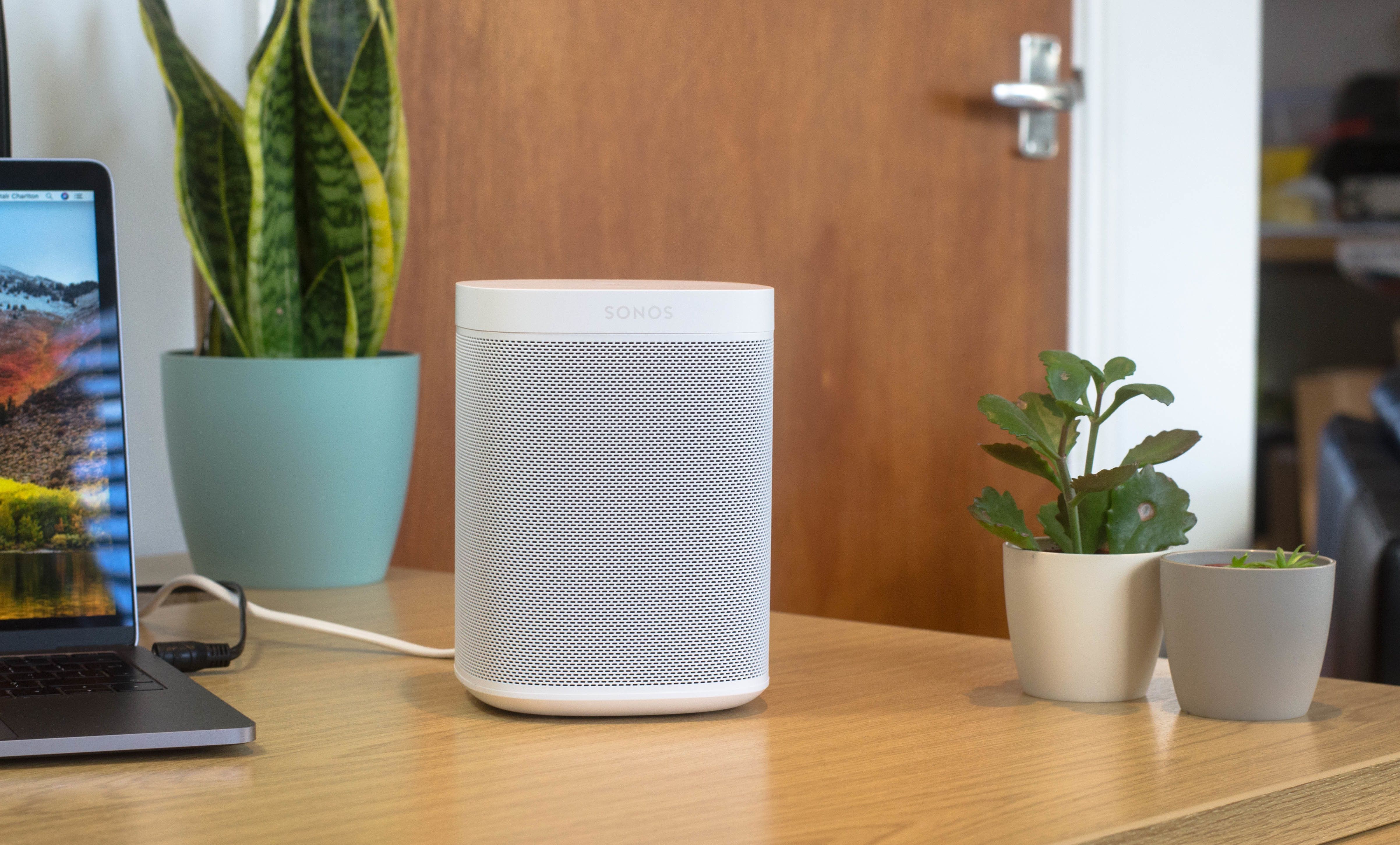 A photo of Sonos One on a desk top.