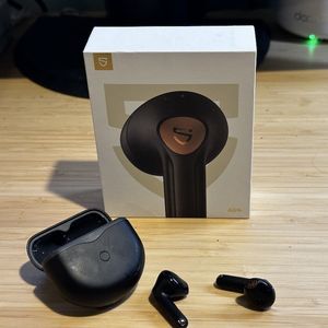 A photo of SoundPEATS Air4 Wireless Earbuds, case and box on a desk
