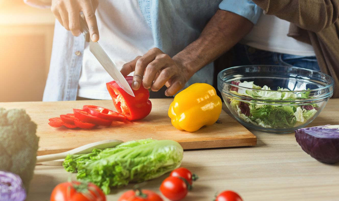 Stock image of a man chopping vegetables