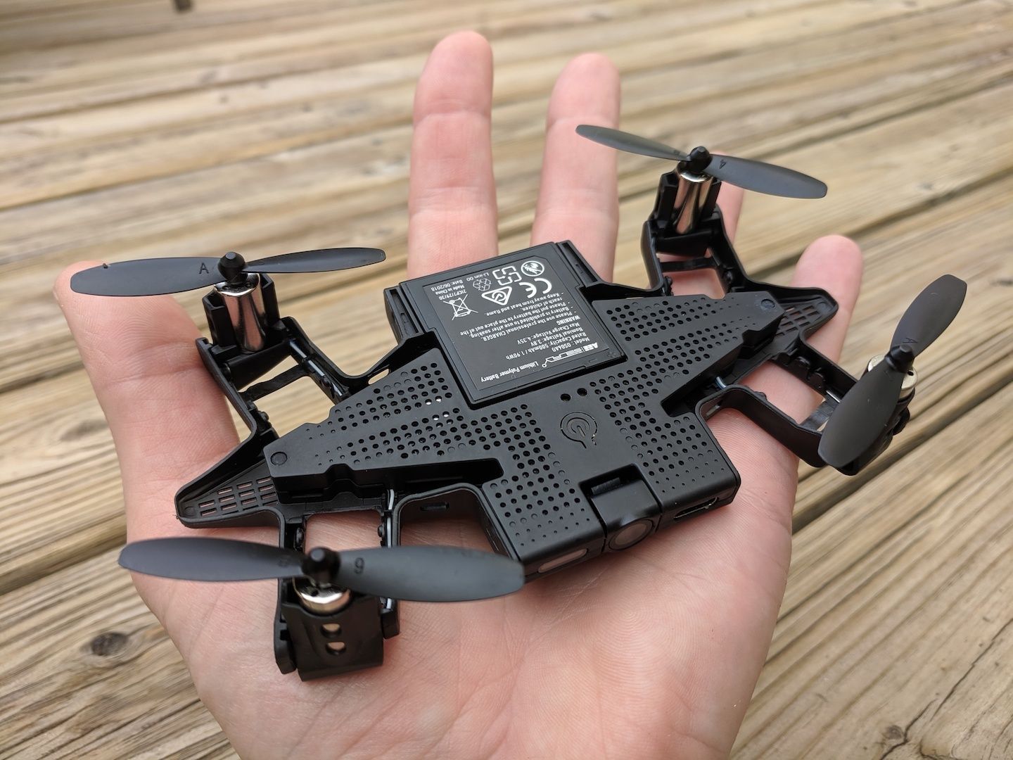 Small black drone in a palm of a hand