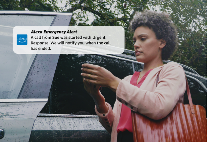 a woman viewing Alexa Emergency Alert message on her smartphone.