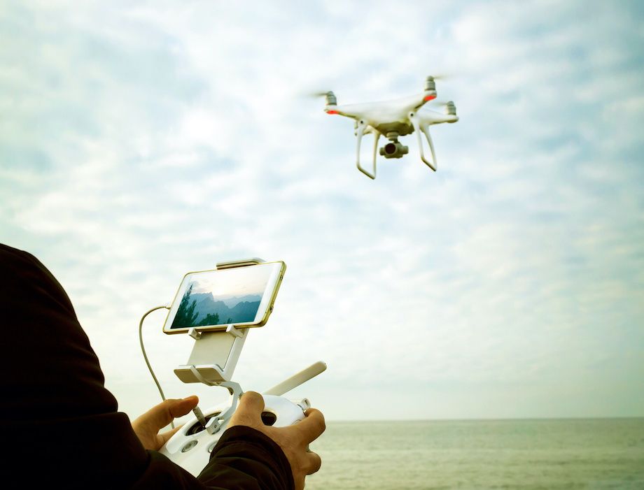 A drone pilot flying a drone 