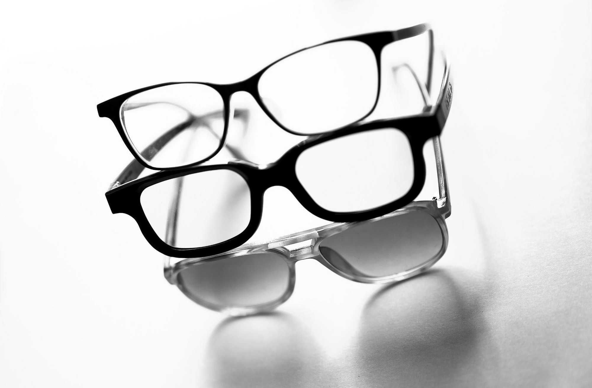 black framed eyeglasses on white surface