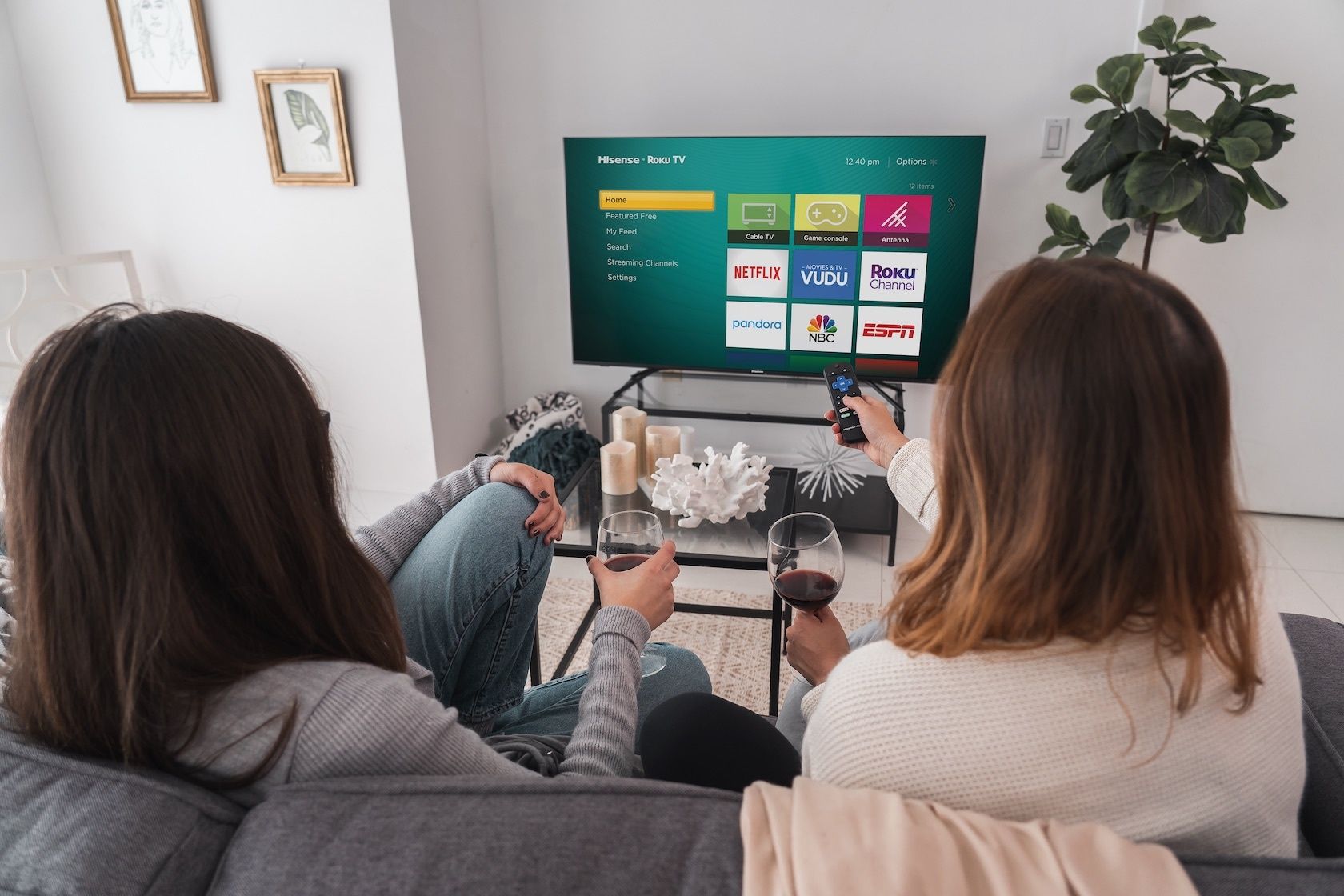 Two people in a living room watching the new Hisense R8F 4K Roku TV