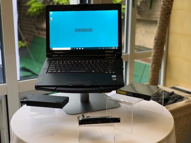 A black laptop computer with a blue screen and the word, 'Toughbook' on the front