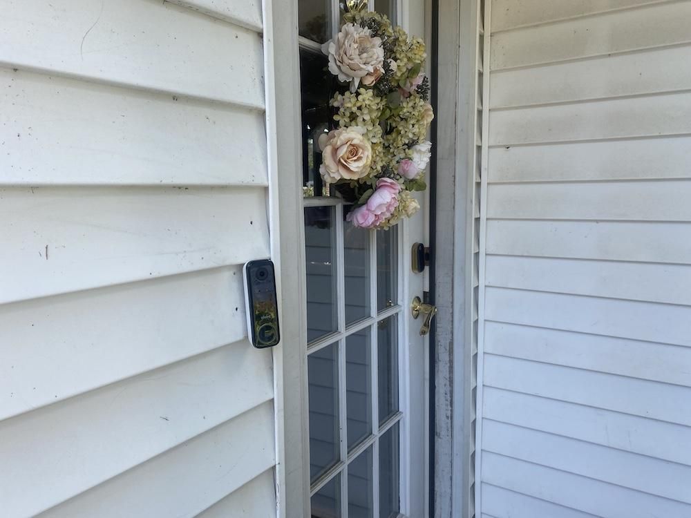 a photo of Vivint Doorbell Camera Pro (Gen 2) installed on a house next to a door