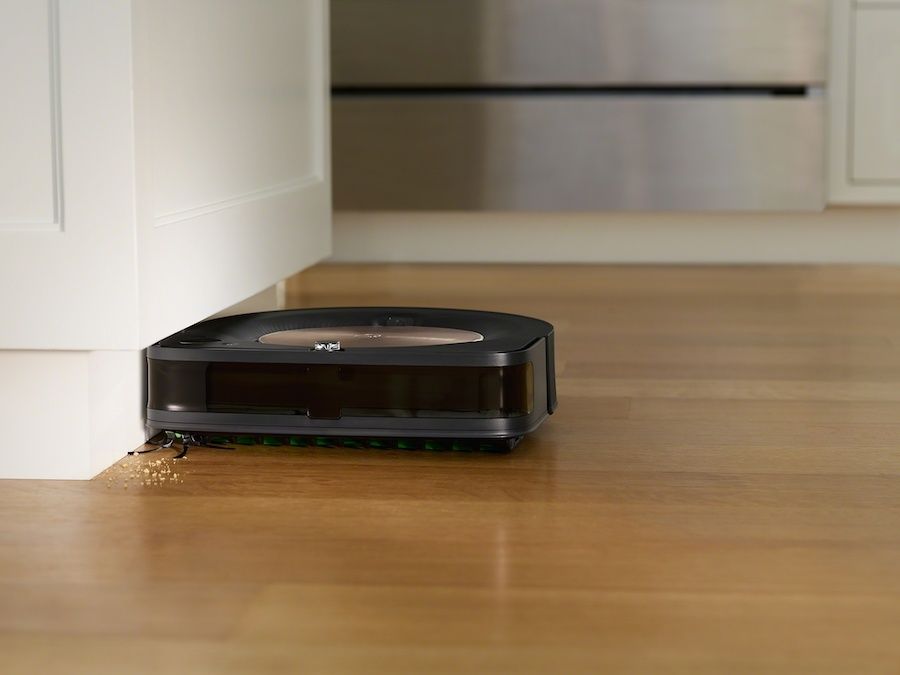 a photo of iRobot Roomba s9+ robot vacuum cleaning a floor